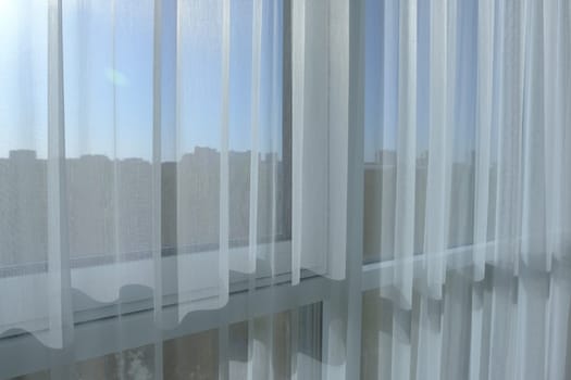 White curtains, translucent sunlight, morning light blurred houses