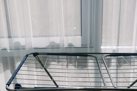 Clothes Dryer Metal Rack Laundry Home near window.