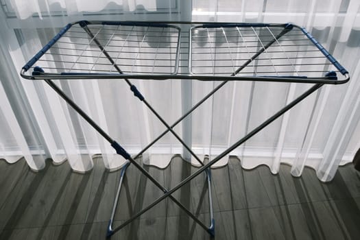 Clothes Dryer Metal Rack Laundry Home near window.