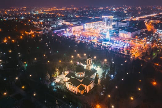 Gomel, Belarus. Main Christmas Tree And Festive Illumination On Square In Homel. New Year In Belarus. Aerial Night View. Peter And Paul Cathedral In Rumyantsevs And Paskeviches Park. Local Landmark.