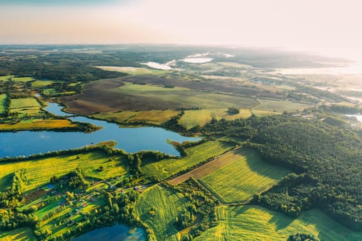 Lyepyel District, Vitebsk Region, Belarus. Aerial View Of Residential Area With Houses In Countryside. Morning Fog Above Lepel Lake. Sun Shining Above Town Skyline And Lepel Lake.