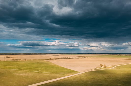 Aerial View. Amazing Natural Dramatic Sky With Rain Clouds Above Countryside Rural Field Landscape In Spring Day. Scenic Sky With Fluffy Clouds On Horizon. Beauty In Nature.