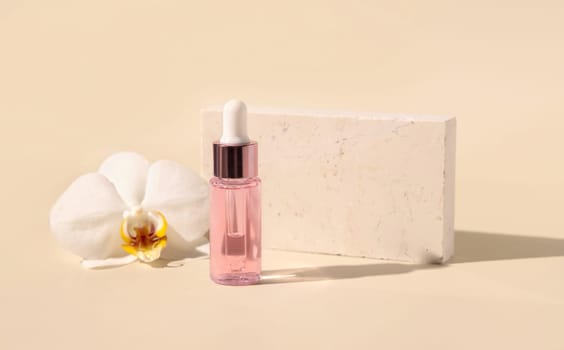 Light Pink Dropper Bottle with serum near white orchid flower on light yellow, close up, mockup. Skincare beauty product, Aromatic oil or serum. Exotic cosmetics, pastel minimal composition..