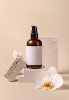 Dark glass one pump cosmetic bottle with blank label near white orchid flowers and stones on light yellow, close up, mockup. Skincare handmade beauty product, tonic or lotion. Exotic natural cosmetics..