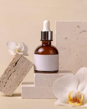 Brown Glass Dropper bottle on stone near white orchid flowers on light yellow close up, label mockup. Skincare handmade beauty product, serum or lotion. Exotic natural cosmetics..