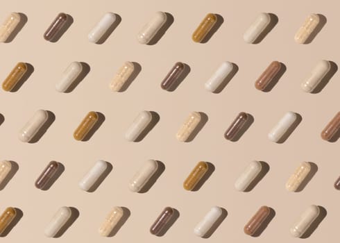 Capsules on light beige top view, hard shadows, creative pattern. Preventive medicine and healthcare, taking dietary supplements and vitamins. Assorted pharmaceutical medicine capsules
