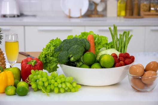 Healthy foods of fresh vegetables, fruits, eggs and pineaple juice on white table in home kitchen . Home healthy lifestyle concept