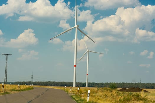 Sustainable green energy. Electric windmill generators in the sunrise