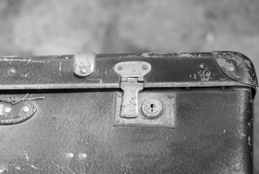 A close-up, detail shot of an old leather suitcase.