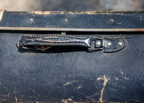 A close-up, detail shot of an old leather suitcase.