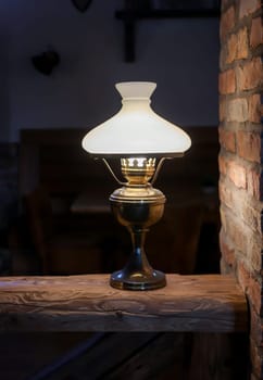 A floor lamp on a base made of a wooden post.