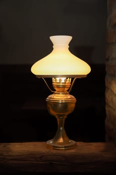 A floor lamp on a base made of a wooden post.