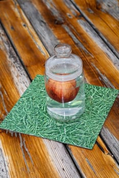 In a jar with a lid in the water apples.