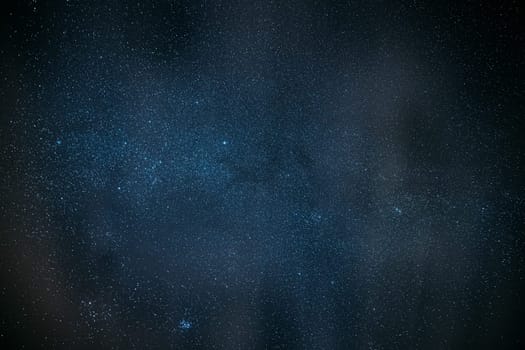 Milky Way Galaxy Glowing Through The Light Cloudiness Overcast. Real Night Sky Stars. Natural Starry Sky Dark Black Background Backdrop.