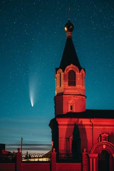 Korma Village, Dobrush District, Belarus. Comet Neowise C2020f3 In Night Starry Sky And St. John The Korma Convent Church In Korma Village. Famous Orthodox Church And Historic Heritage.