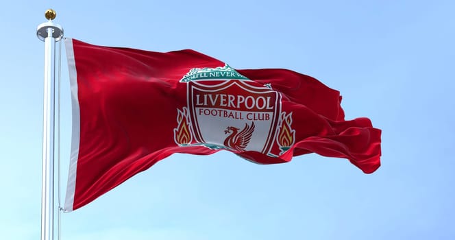 Liverpool, UK, May 2022: The flag of Liverpool Football Club waving in the wind on a clear day. Liverpool F.C. is a professional football club based in Liverpool, England