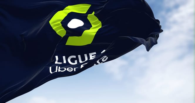 Paris, FRA, July 2022: Close-up of the Ligue 1 flag waving in the wind. Ligue 1 is a French professional league for men association football clubs. Illustrative editorial