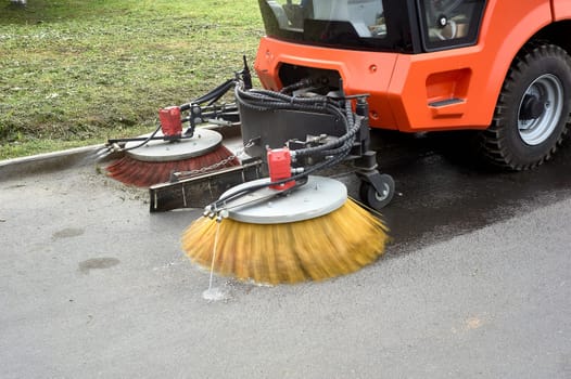 A special machine sweeps city paths. High quality photo