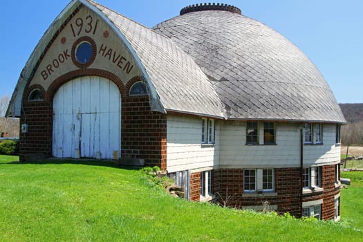 Old fashion round barn with brick on lower level in New York state