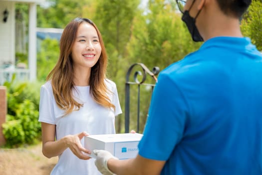 Sick Asian young woman receive medicine first aid pharmacy box from hospital delivery service, happy female receiving patient medicine drug from delivery man, healthcare medicine online concept