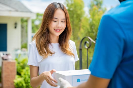 Sick Asian young woman receive medication first aid pharmacy box from hospital delivery service, delivery man give medicine drug to patient female at home, healthcare medicine online concept