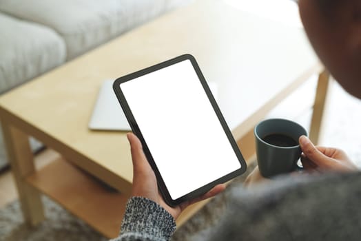 close-up women using digital tablet white screen in living room