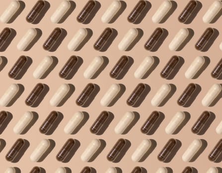 Capsules on light beige top view, hard shadows, creative pattern. Preventive medicine and healthcare, taking dietary supplements and vitamins. Assorted pharmaceutical medicine capsules