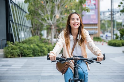 Happy Asian young woman riding bicycle on street outdoor near building city, Portrait of smiling female lifestyle use mountain bike in summer travel means of transportation, ECO friendly, Urban biking