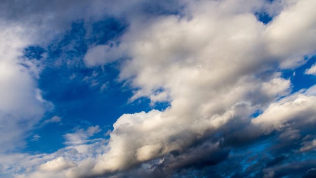 Clouds illuminated by the sun in the sky as background. Background image for further editing