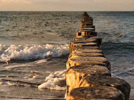 the Baltic Sea through the sea to the horizon at sunset. Romantic mood on vacation in Zingst