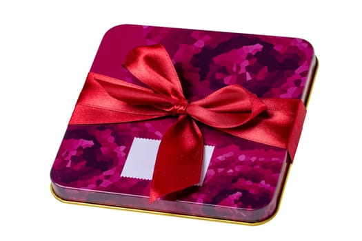 Closeup of a decorative red pink present or gift box with ribbon bow isolated on a white background. Clipping path. Birthday, Christmas, Valentine's Day. Macro.