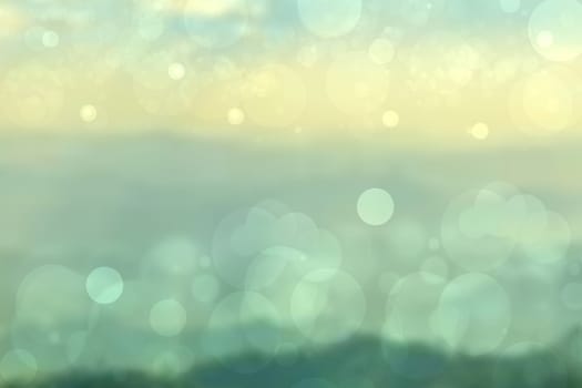 Abstract bright spring or summer landscape texture with natural green bokeh lights and yellow circular lights with sunshine and sun rays. Beautiful autumn background with copy space.