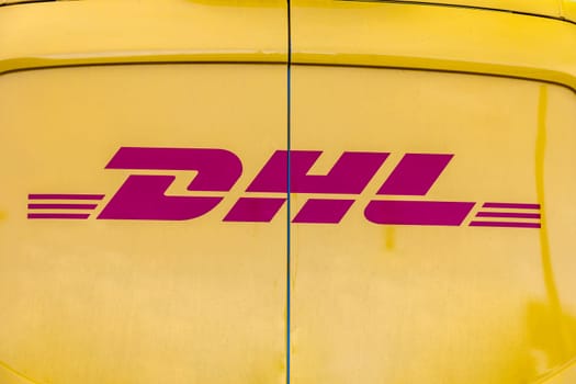 WETZLAR, GERMANY - 2021-10-01: DHL Logo on a yellow DHL Truck. DHL is owned by the German postal service Deutsche Post.