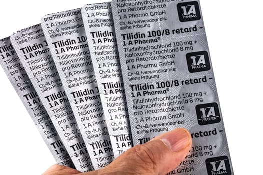 WETZLAR, GERMANY 2022-04-21: Hand hold blisters of TILIDIN PAINKILLER. Tilidin is a pain-relieving drug from the group of opioids.