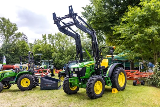 GERMANY - WETZLAR JULY 08: JOHN DEERE Tractor with hydraulic grab. John Deere is an American manufacturer of agricultural, forestry and construction machinery.