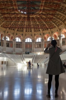 Barcelona, Spain - Dec 26th 2019: Tourist taking pictures to Great Hall of Palau Nacional building. Barcelona, Spain