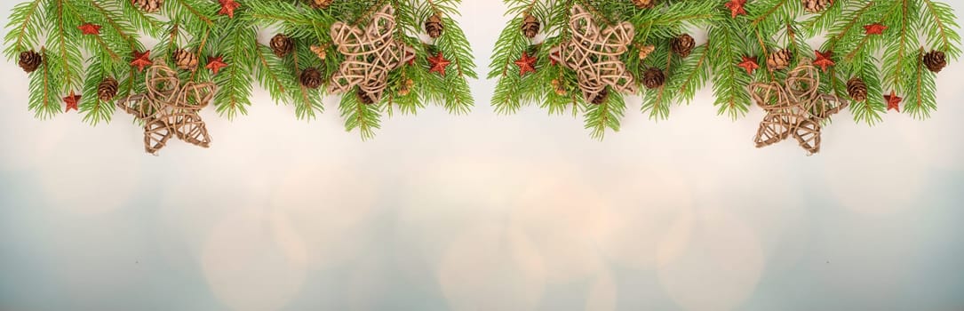 Christmas holiday background, fir branches, red stars and cones, winter season greeting card with bokeh lights and copy space