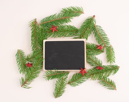 Christmas holiday background, chalkboard with fir branches and red stars, winter season greeting card with copy space