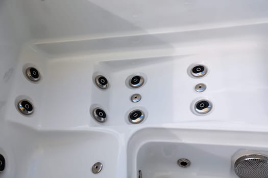 Details of a whirlpool with many jets for massage.