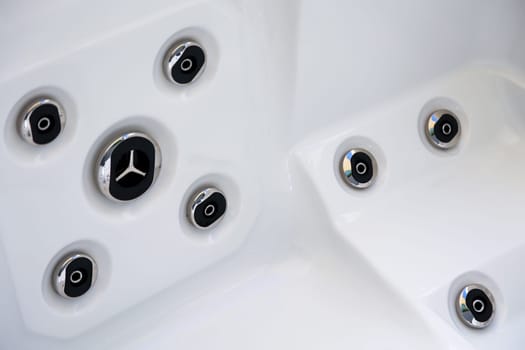 Details of a whirlpool with many jets for massage.