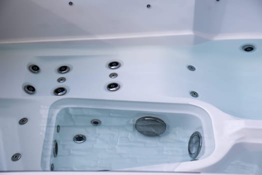 Details of a whirlpool with many jets for massage.