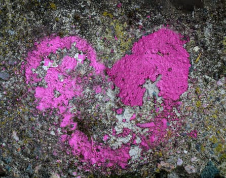 The remains of a pink colored heart on a stone.
