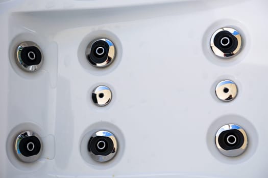 Details of a whirlpool with many jets for massage.