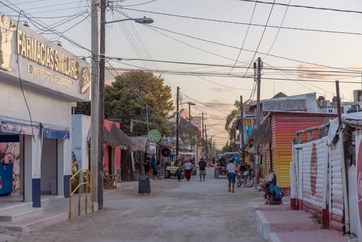 Tourists on a sandy road in Holbox Island, Quintana Roo, Mexico