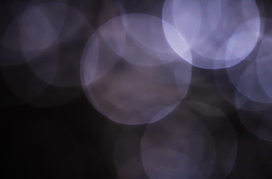 Light abstract dark bokeh christmas circle color glitter blurred black background