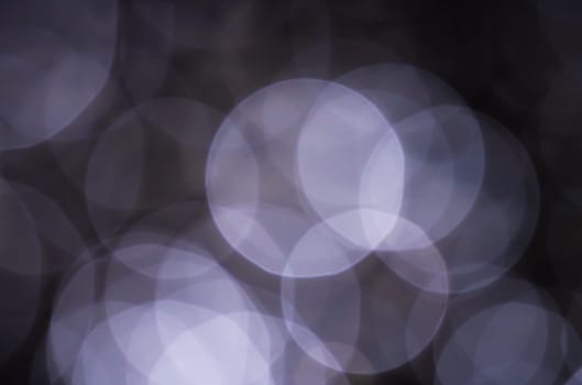 Light abstract dark bokeh christmas circle color glitter blurred black background
