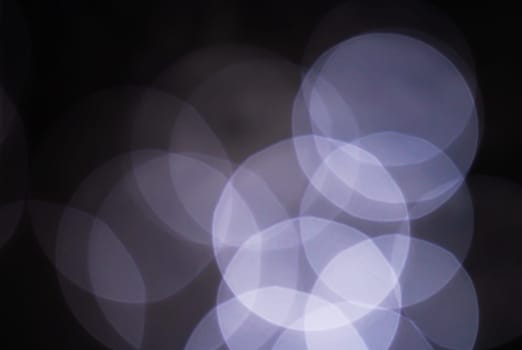 Light abstract dark bokeh christmas circle color glitter blurred black background