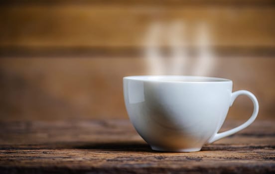 A cup of coffee with coffee bean on wooden background dark tone dtyle