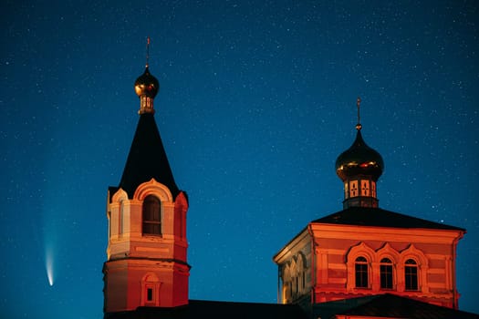 Korma Village, Dobrush District, Belarus. Comet Neowise C2020f3 In Night Starry Sky And St. John The Korma Convent Church In Korma Village. Famous Orthodox Church And Historic Heritage.