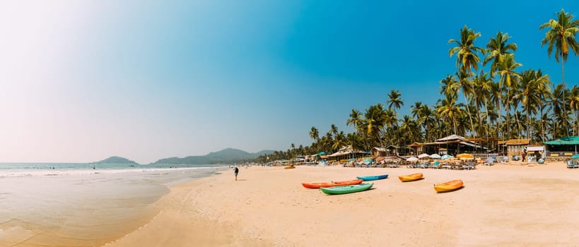 Canacona, Goa, India. Canoe Kayak For Rent Parked On Famous Palolem Beach On Background Tall Palm Tree In Summer Sunny Day.